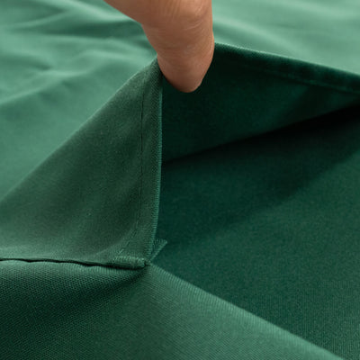 Close-up of green fabric showing texture and fold detail.