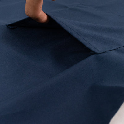 Navy blue fabric with a hand revealing a pocket detail.