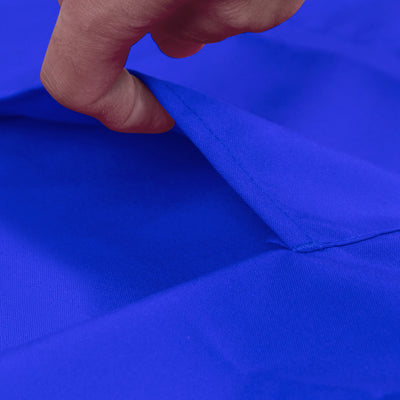 Close-up of a hand pulling back a vibrant blue fabric.