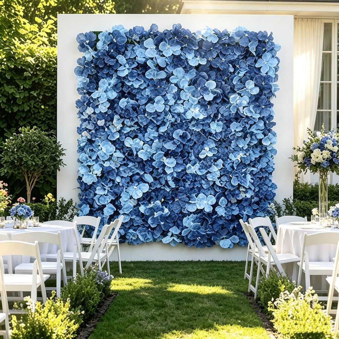 Blue floral wedding backdrop with white chairs and outdoor garden reception tables