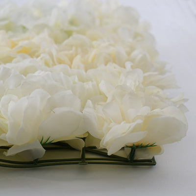White artificial flower arrangement on a green base.