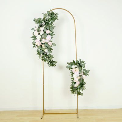 Gold floral arch with pink roses and greenery on a plain background