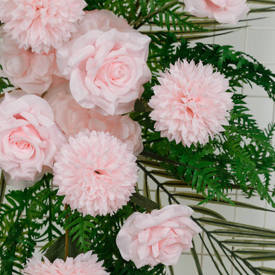 Pink roses and dahlias with green foliage on a white background.