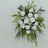 White floral arrangement with roses, chrysanthemums, and greenery