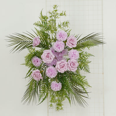 Floral arrangement with pink roses and purple flowers against a white background
