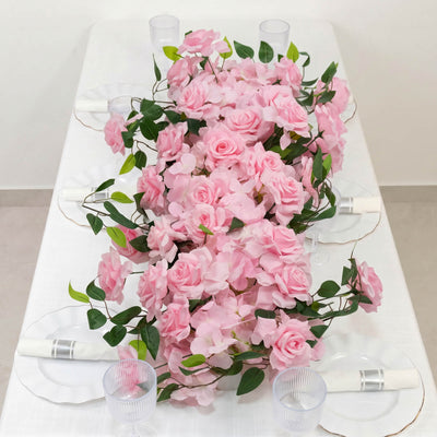 Pink rose floral table centerpiece with white tableware and glassware