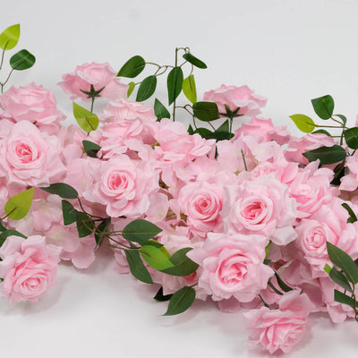 Pink roses and green leaves floral arrangement on a white background
