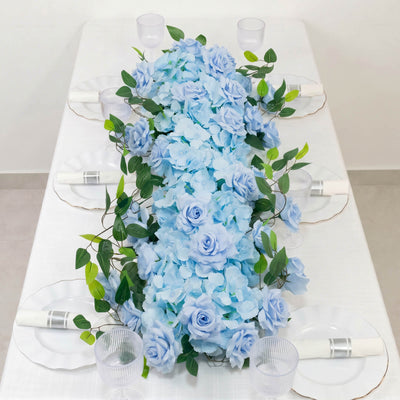 Blue floral wedding table centerpiece with roses, hydrangeas, and greenery