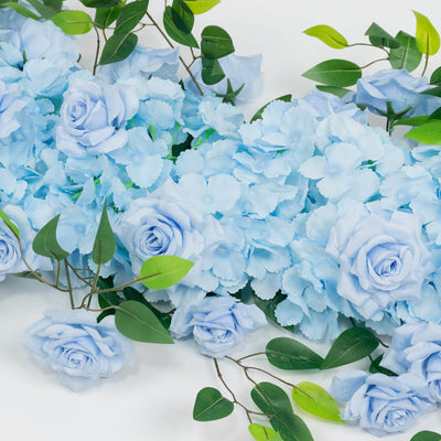 Light blue roses and hydrangeas with green leaves on white background