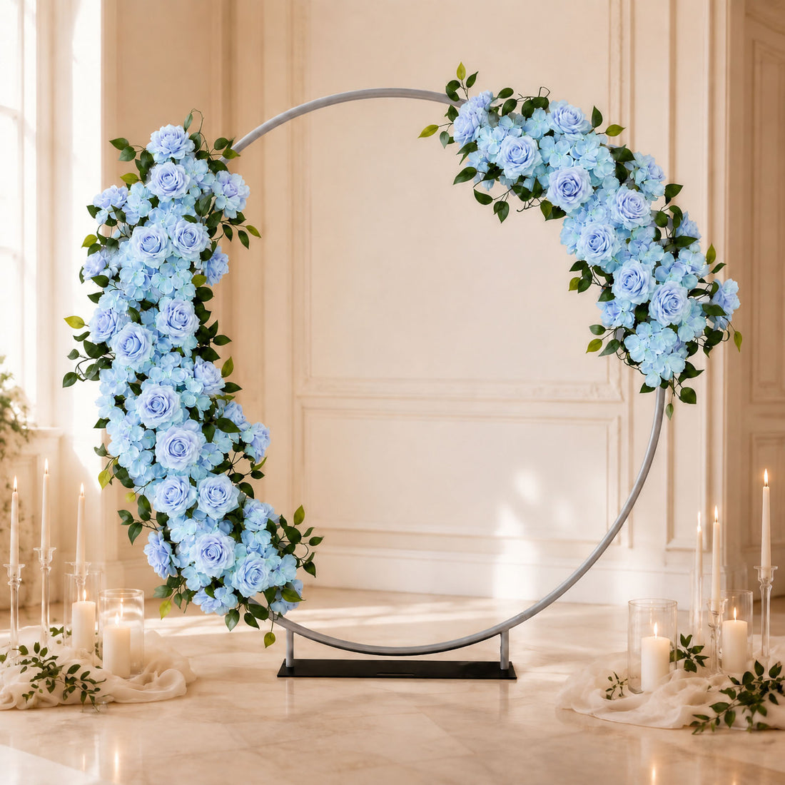 Blue floral wedding arch with roses, hydrangeas, and candles in elegant venue