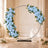 Blue floral wedding arch with roses, hydrangeas, and candles in elegant venue