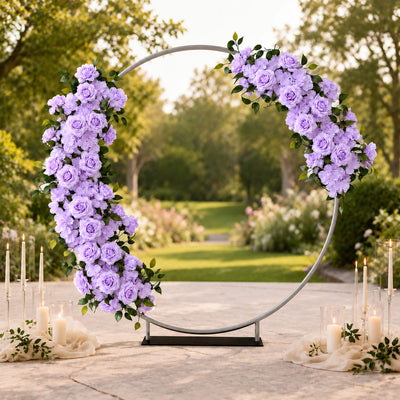 Lavender floral wedding arch with candles in an outdoor garden setting