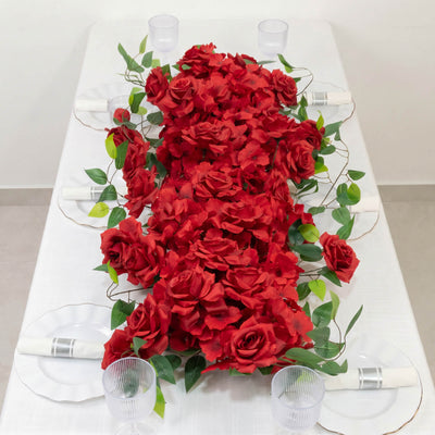 Red rose and greenery wedding table centerpiece with white place settings