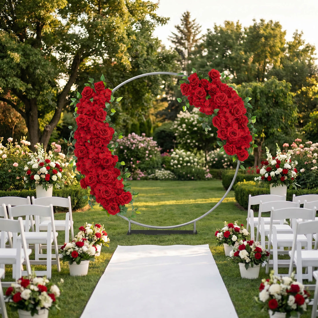 Outdoor wedding ceremony aisle with red rose floral arch and white chairs