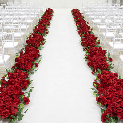 White wedding aisle with red rose floral arrangements and chairs