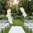 Elegant outdoor wedding ceremony setup with floral arch and white chairs