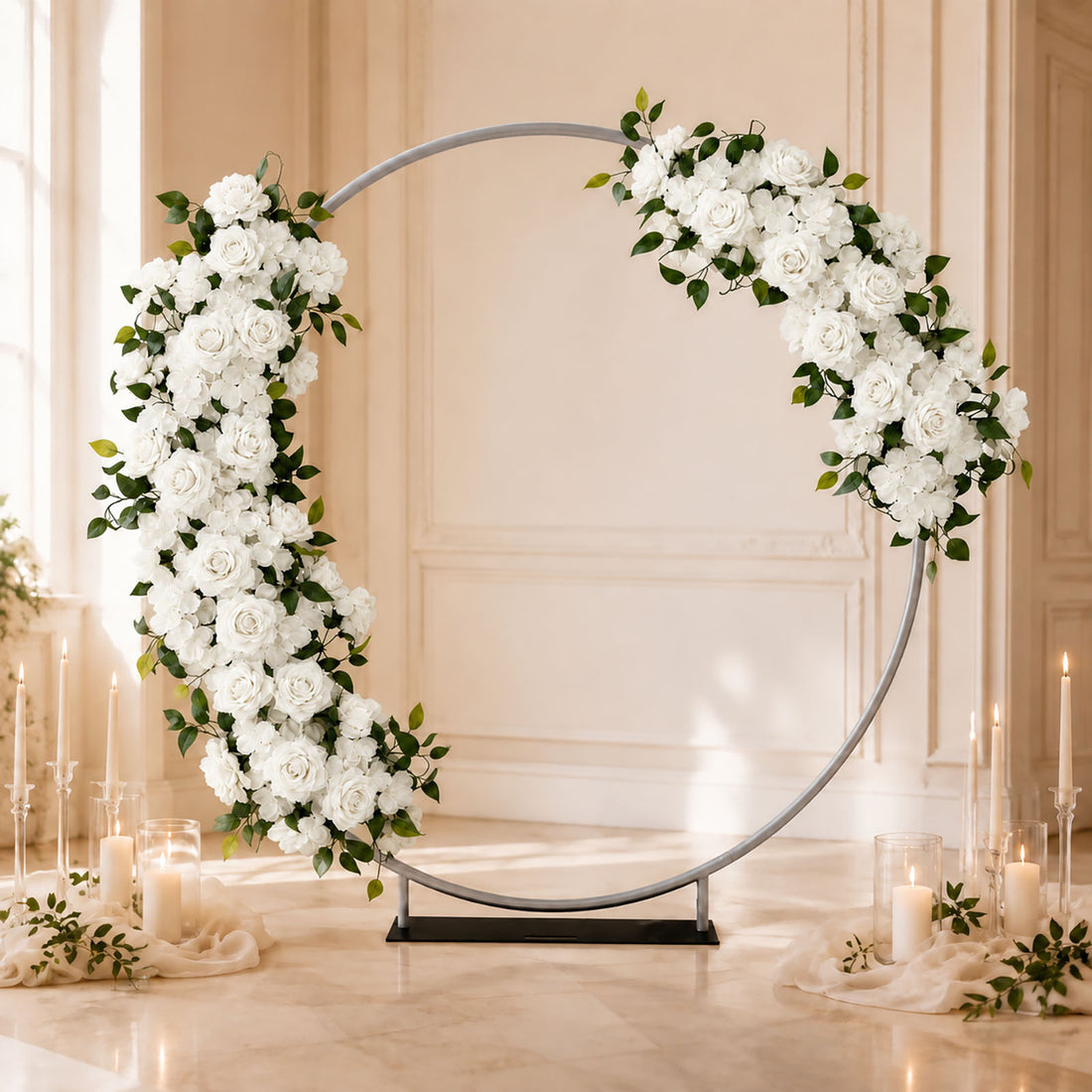 Elegant white floral wedding arch with candles in a luxury indoor venue