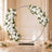 Elegant white floral wedding arch with candles in a luxury indoor venue