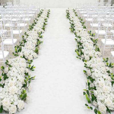 Elegant white wedding aisle with floral arrangements and white chairs