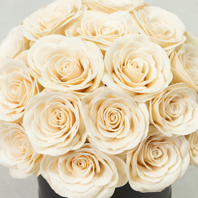 Cream-colored rose bouquet in a round arrangement.
