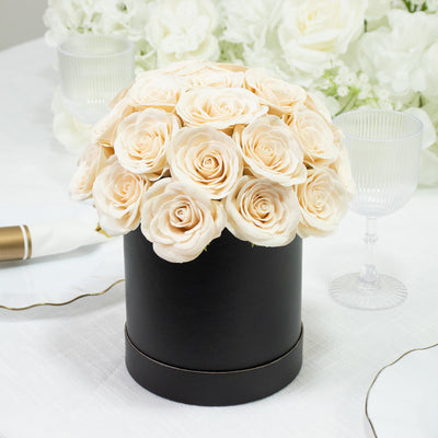 Elegant cream roses in a black hat box centerpiece.