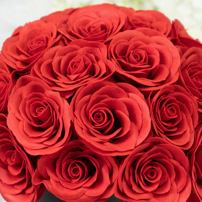 Red rose bouquet with detailed petals in a round arrangement.