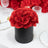 Black box with red roses, perfect for elegant decor or gifts.