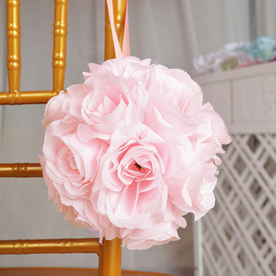 Pink flower bouquet decoration hanging from a chair.