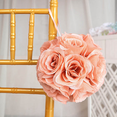 Peach rose flower ball hanging from a gold chair.