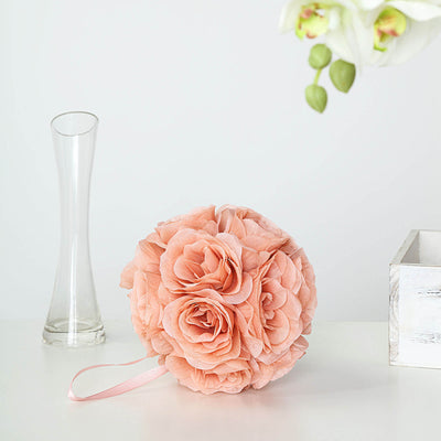 Peach floral bouquet with ribbon handle on a table