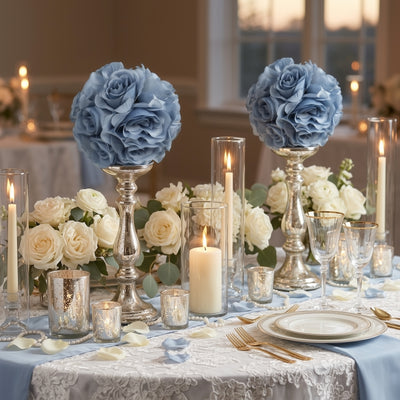 Elegant blue rose centerpieces with candles and silver accents for a romantic table setting.
