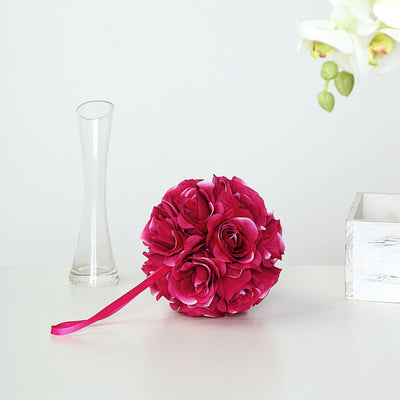 Pink rose bouquet with ribbon handle on a plain white background