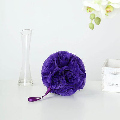 Purple floral bouquet with a ribbon on a plain background.