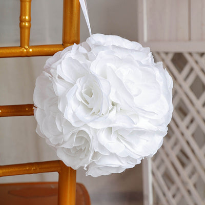 White floral pomander hanging from a chair in a soft setting.