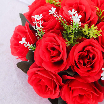 Red artificial rose bouquet with green accents.