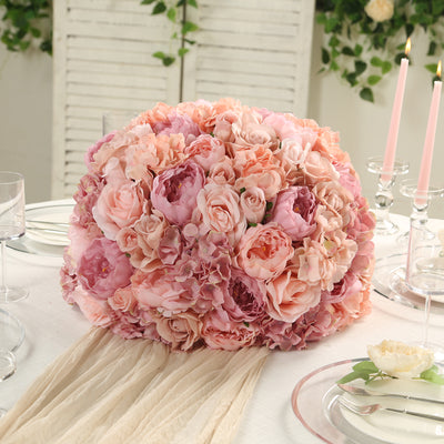 Pink floral centerpiece arrangement on a table with elegant decor.