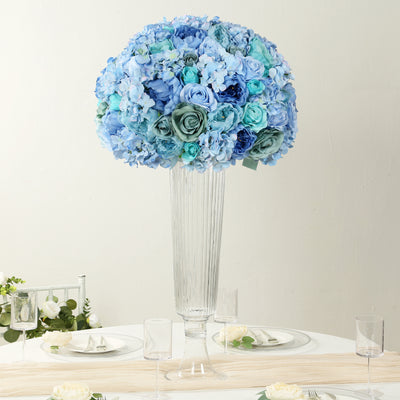 Elegant blue floral arrangement in tall glass vase for event decor.