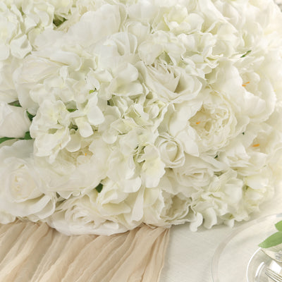 White floral bouquet arrangement on a soft fabric background.
