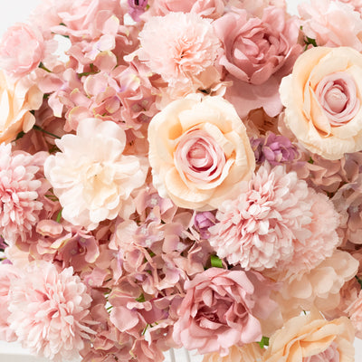 Pink artificial flower bouquet in various shades and textures.