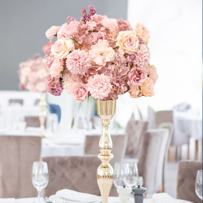 Elegant pink floral centerpiece in a stylish restaurant setting.