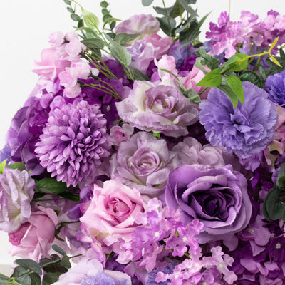 Purple floral arrangement featuring roses, chrysanthemums, and lilacs.