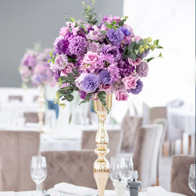 Purple floral centerpiece in a stylish dining setting.
