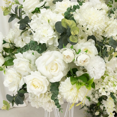 White floral arrangement with roses, hydrangeas, and greenery.