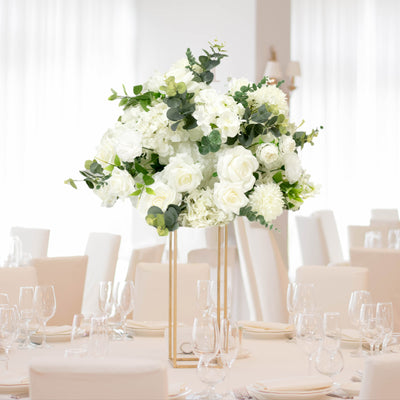Elegant white floral centerpiece for event table setting.