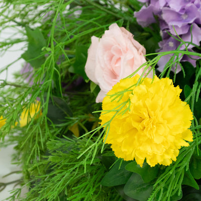 Yellow carnation bouquet with pink and purple flowers, close-up floral arrangement#whtbkgd