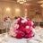 Elegant pink and white floral wedding reception table centerpiece with candles