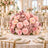 Pink floral wedding centerpiece with candles on an elegant gold table setting