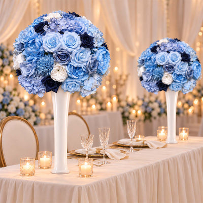 Blue floral wedding centerpieces with candles on an elegant reception table