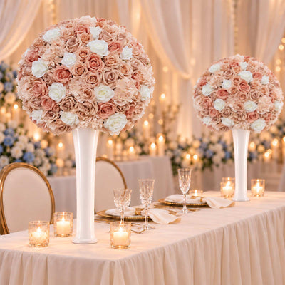 Elegant wedding table with blush floral centerpieces and candlelit decor