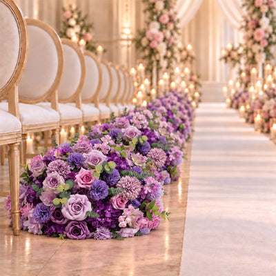 Elegant wedding aisle with purple floral arrangements and gold chairs